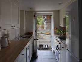 A kitchen with a sink and door leading to outdoor area at Gatekeepers Cottage in Myddfai near Llandovery
