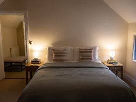 A bedroom with a bed and lamps at Gatekeepers Cottage in Myddfai near Llandovery