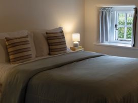 A bedroom with a bed and lamp at Gatekeepers Cottage Myddfai near Llandovery