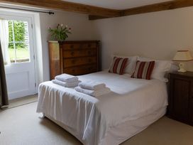 A bedroom with a bed and dresser at Gatekeepers Cottage in Myddfai near Llandovery