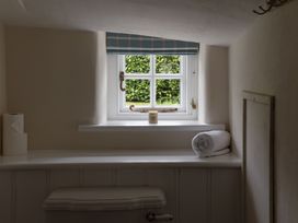 A bathroom with a window and a towel at Gatekeepers Cottage, Myddfai near Llandovery
