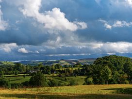 A landscape view of rolling hills and clouds at North Cottage in Llandovery