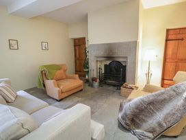 A living room with a fireplace and seating area at North Cottage Llandovery