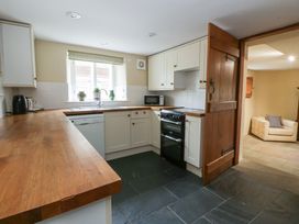 A kitchen with wooden countertop and appliances at North Cottage in Llandovery