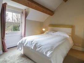 A bedroom with a bed and window at North Cottage Llandovery