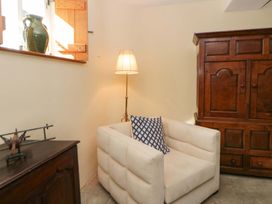 A living room with a chair and lamp at North Cottage Myddfai near Llandovery