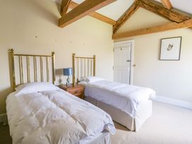 A bedroom with two beds and a nightstand at North Cottage Myddfai near Llandovery