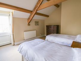 A bedroom with two beds and a chest of drawers at North Cottage Myddfai near Llandovery
