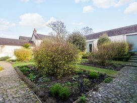 A garden with pathways and shrubs at North Cottage in Myddfai near Llandovery