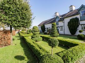 A garden with trimmed hedges and trees at North Cottage in Myddfai near Llandovery