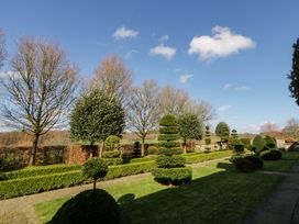 A garden with topiary trees and hedges at North Cottage Myddfai near Llandovery