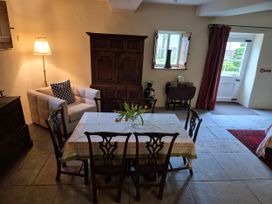 A dining room with a table and chairs at North Cottage in Myddfai near Llandovery