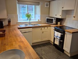 A kitchen with a sink and stove at North Cottage in Myddfai near Llandovery