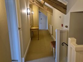 A hallway with a table and a door at North Cottage in Myddfai near Llandovery