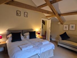 A bedroom with two single beds and a sofa at North Cottage Myddfai near Llandovery