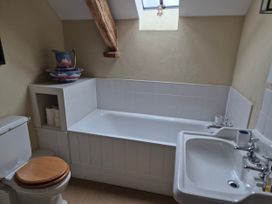 A bathroom with a bathtub, toilet, and sink at North Cottage Myddfai near Llandovery