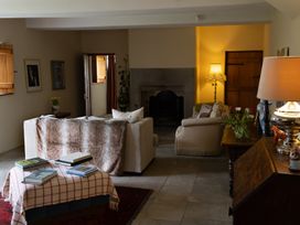 A living room with a sofa, armchair, and coffee table at North Cottage Myddfai near Llandovery