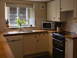 A kitchen with a sink and appliances at North Cottage in Myddfai near Llandovery