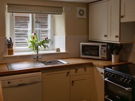A kitchen with a sink and dishwasher at North Cottage in Myddfai near Llandovery