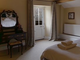 A bedroom with a bed and mirror at North Cottage in Myddfai near Llandovery