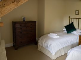 A bedroom with a bed, dresser and towels at North Cottage Myddfai near Llandovery