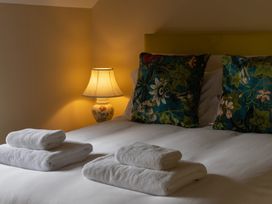 A bedroom with a bed and lamps at North Cottage Myddfai near Llandovery