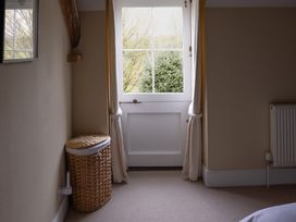A bedroom with a window and door at North Cottage Myddfai near Llandovery