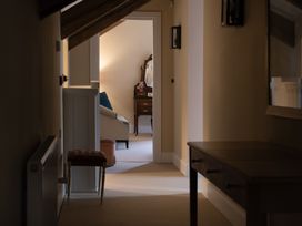 A hallway with a dressing table and armchair at North Cottage Myddfai near Llandovery