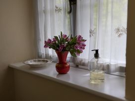 A flower vase with flowers on a windowsill at North Cottage Myddfai near Llandovery