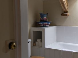 A bathroom with a bathtub and a toilet at North Cottage Myddfai near Llandovery