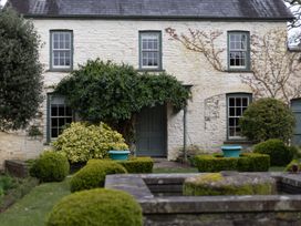 An exterior view of a house with plants in the garden at North Cottage in Myddfai near Llandovery