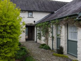 An outdoor view of a cottage with a pathway and greenery at North Cottage Myddfai near Llandovery