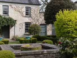 A garden with a fountain and topiary at North Cottage in Myddfai near Llandovery