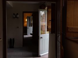 A hallway with doors and a lamp at North Cottage Myddfai near Llandovery