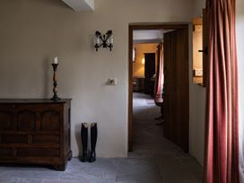 A hallway with a chest and candlestick at North Cottage in Myddfai near Llandovery