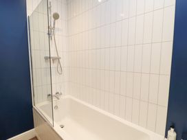 A bathroom with a bathtub and shower at Peewit Coach House in Moreton-in-Marsh