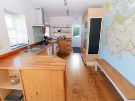 A kitchen with wooden countertops and a map on the wall at Hawthorns in Swansea
