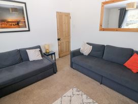 A living room with two sofas and a table at Hawthorns in Swansea