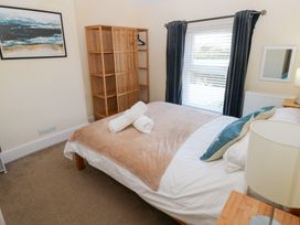 A bedroom with a double bed and a wardrobe at Hawthorns in Swansea