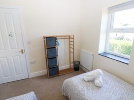 A bedroom with storage and a bed at Hawthorns in Swansea
