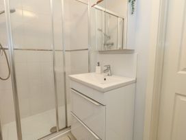 A bathroom with a shower and a sink at June Cottage in Wool