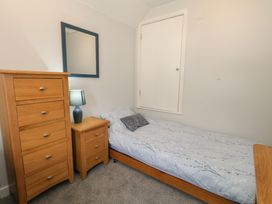 A bedroom with a bed and furniture at June Cottage in Wool