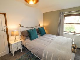 A bedroom with a bed and a bedside table at Clawddcam in Mathry