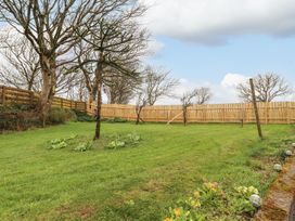 A garden with grass and trees at Clawddcam in Mathry