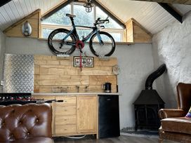 A kitchen with a bicycle on the wall and a coffee maker at Clawddcam in Mathry