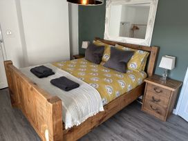 A bedroom with a bed and nightstand at Clawddcam in Mathry