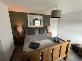 A bedroom with a bed and lamps at Clawddcam in Mathry