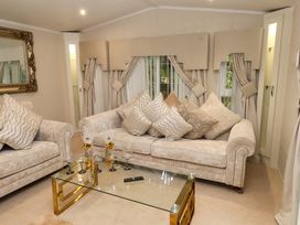 A living room with sofas and a coffee table at The Chalet at Tyn Lon in Chwilog
