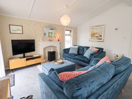 A living room with sofa and television at Charnwood