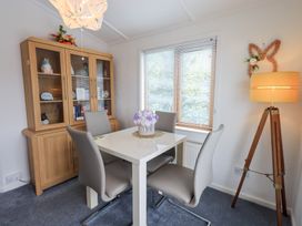 A dining room with a table and chairs at Charnwood in 